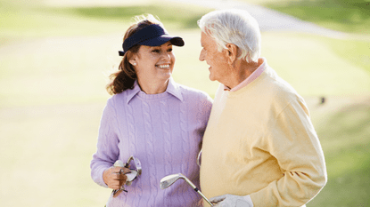 Elderly couple happy playing golf