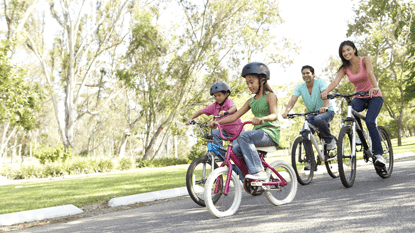 Happy family riding bikes together