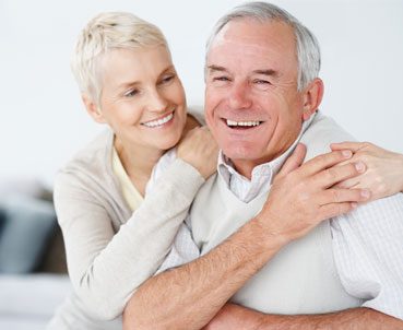 Elderly couple smiling and laughing