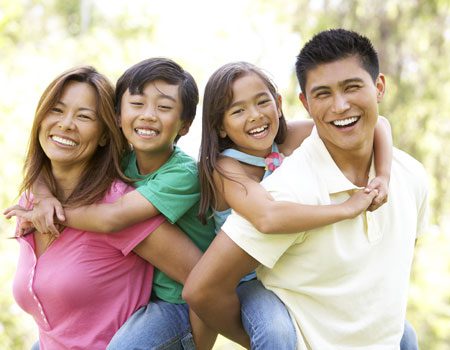 Happy family holding their kids and smiling