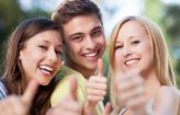 Happy teens giving a thumbs up