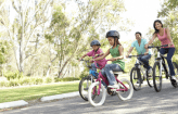 Happy family riding bikes together
